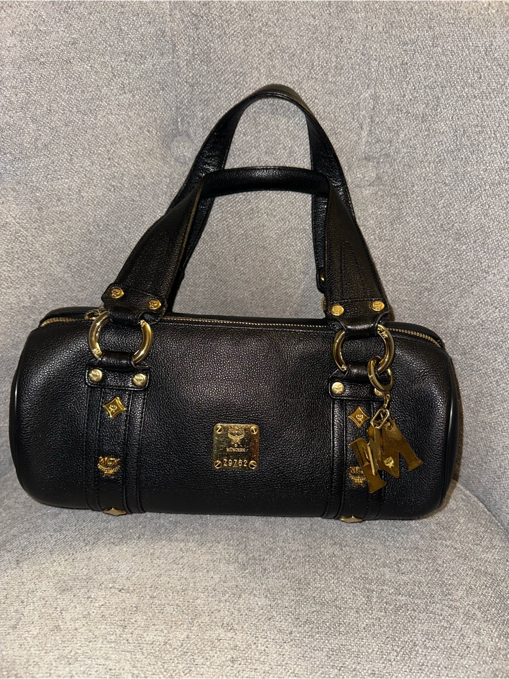 MCM Black Leather Barrel Bag with Gold Hardware Charms